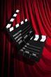 Movie clapper board against curtain