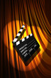 Movie clapper board against curtain