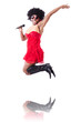 Man in female clothing singing with mic