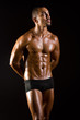 Muscular man in dark studio