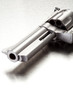 Gun on brushed metal surface