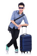 Young guy with travel case on white
