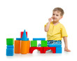 little boy is playing with colorful building blocks isolated on