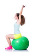 Young woman with ball exercising on white