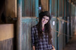 Attractive woman standing at horse ranch