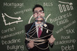 Photo: Crazy businessman tied in rope and cable at class Crazy businessman tied in rope and cable at class