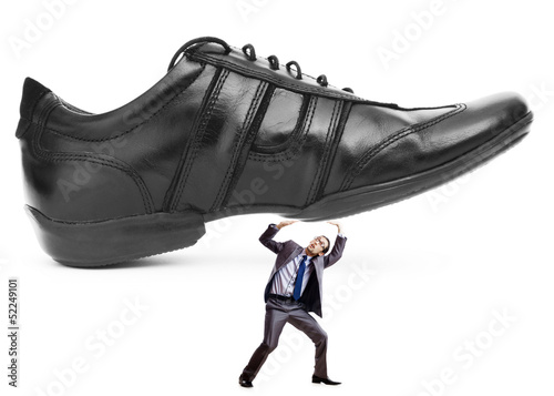 Photo: Woman domination concept with shoes and man Woman domination concept with shoes and man