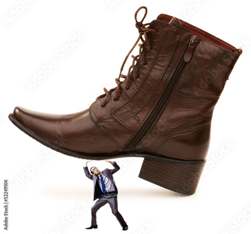 Photo: Woman domination concept with shoes and man Woman domination concept with shoes and man