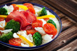 Gluten-free pasta with cherry tomatoes, broccoli and bresaola