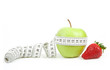 Measuring tape wrapped around a green apple as a symbol of diet