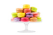 french colorful macarons in a glass cake stand