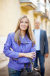 Man walks behind woman