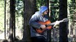 Video: Man playing guitar in the woods leaning against tree/episode 3/ Man playing guitar in the woods leaning against tree/episode 3/