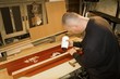man sticks wood glue