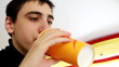 Portrait of happy little boy drinking orange juice.