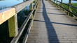 wooden bridge railings lake nature people legs walk