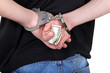 Handcuffs in Hands with Money