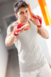 Boxer with red gloves in a gym