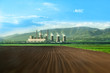 Huge chimnieys of thermal power plant behind a huge field