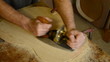 Luthier giving  wood  planer  to  flamenco  guitar