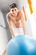Smiling man with blue gym ball