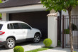 White car in front of the house waiting to enter in the garage
