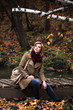 Young blond woman in autumn forest