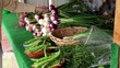 Shopper examines the fresh vegetables in the Farmers market