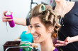 Hairdresser - hair stylist curling hairs