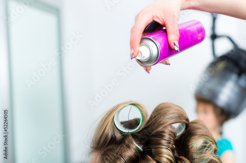 Photo: Hairdresser - hair stylist curling hairs Hairdresser - hair stylist curling hairs