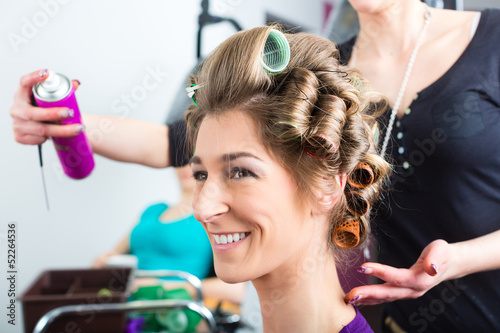 Photo: Hairdresser - hair stylist curling hairs Hairdresser - hair stylist curling hairs