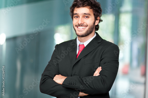 Photo: Handsome businessman in a modern office Handsome businessman in a modern office