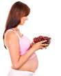 Pregnant woman eating fruit.