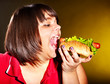 Woman eating hamburger.