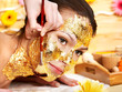 Woman getting  facial mask .