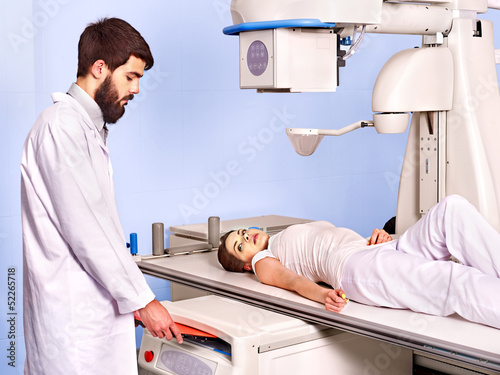 Photo: Patient in x-ray room looking at doctor. Patient in x-ray room looking at doctor.