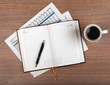 Notepad and coffee cup on wood table