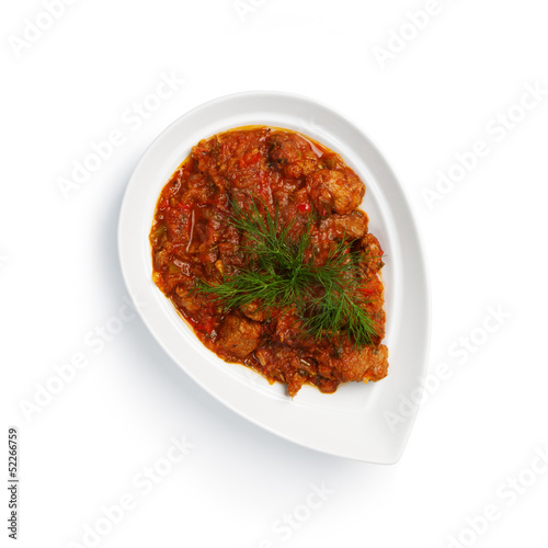 Photo: meat in a sauce on a white plate meat in a sauce on a white plate