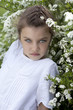 Portrait of beautiful little girl in spring blossom