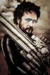 Photo: Desert warrior with big gun wearing a latex armor Desert warrior with big gun wearing a latex armor