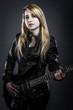 Foto: Teenager holding a black electric guitar Teenager holding a black electric guitar