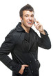 Photo: Young man talks by mobile phone Young man talks by mobile phone