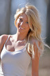 Stunning young blonde model smiling outside