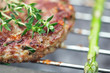 raw burgers on bbq  barbecue grill with fire