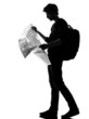 young man silhouette backpacker reading map