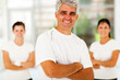 middle aged sporty man in front of family