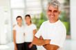 sporty mature man in front of family