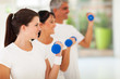 Photo: side view of fit family exercising with dumbbells side view of fit family exercising with dumbbells