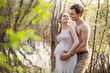 Photo: Young pregnant couple at the river in spring Young pregnant couple at the river in spring
