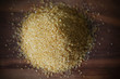 Brown sugar from cane, crystals in heap on brown wooden board